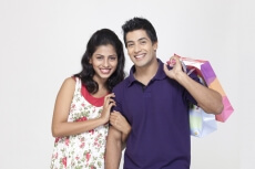 couple posing with shopping bags