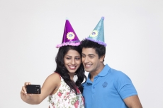 couple smiling while taking their picture from mobile camera 