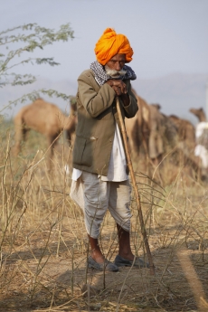 rural man standing with a laathi 