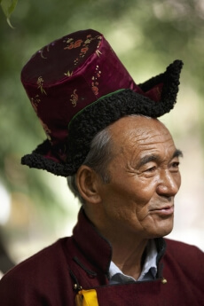 old man wearing the traditional dress at the ladakh festival