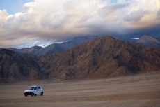 car driving through the beautiful mountain range of ladakh 
