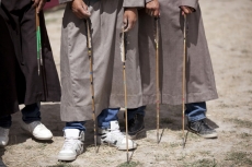 below waist picture of ladakhi children playing with arrow 