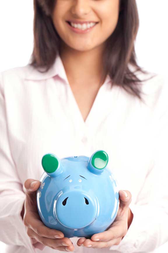 close up shot of girl holding piggy bank