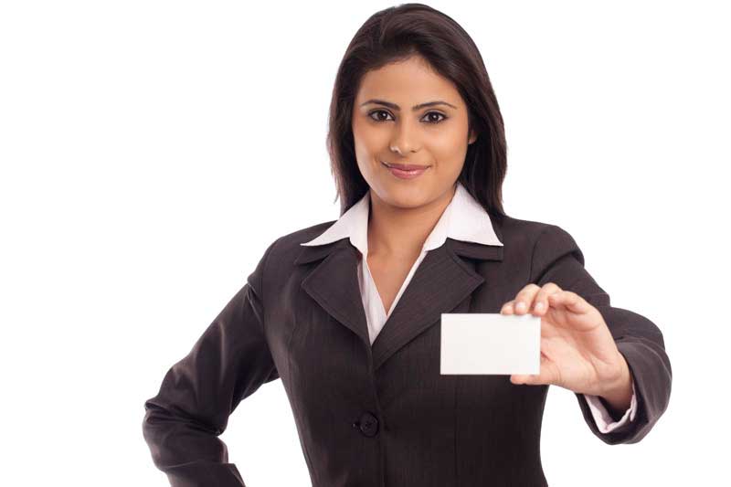 smiling corporate lady handing a business card