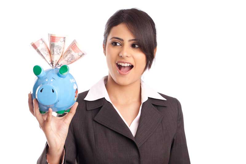 excited girl holding piggy bank with money