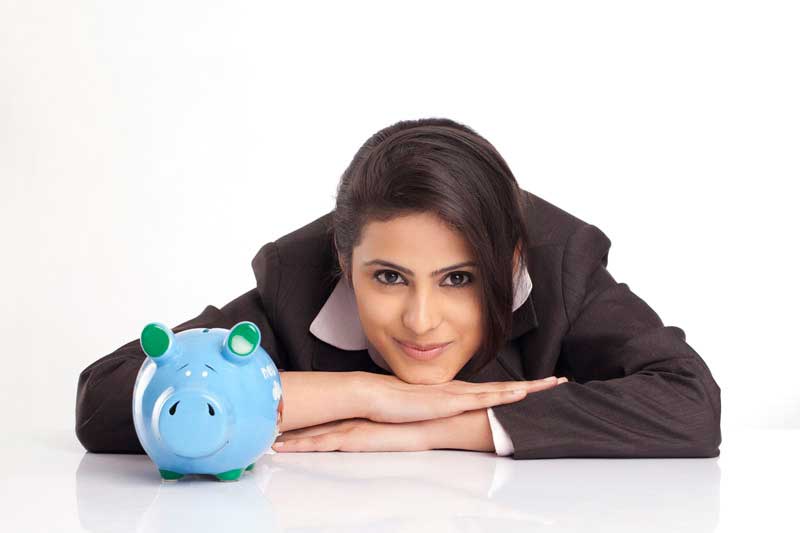 smiling young business woman with a blue piggy bank