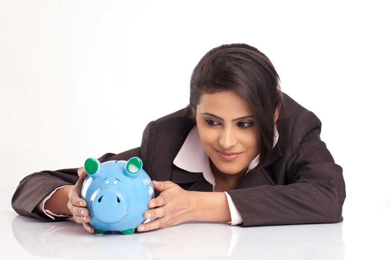 smiling young business woman with a blue piggy bank