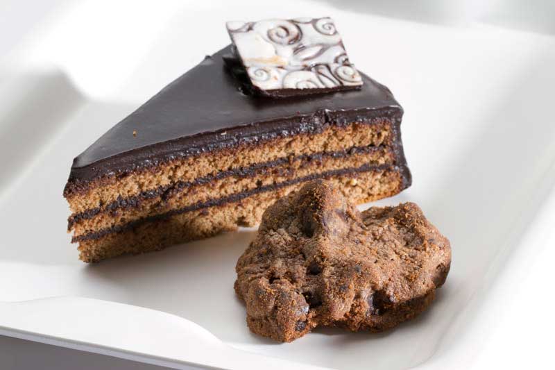 a chocolate flavored piece of cake served with cookie