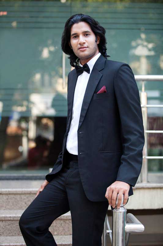 young man posing in suit
