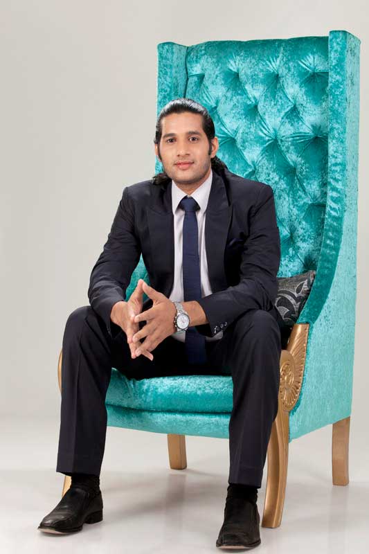 a business man sitting on chair posing for the camera