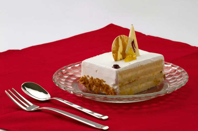 a piece of vanilla cake on a red cloth