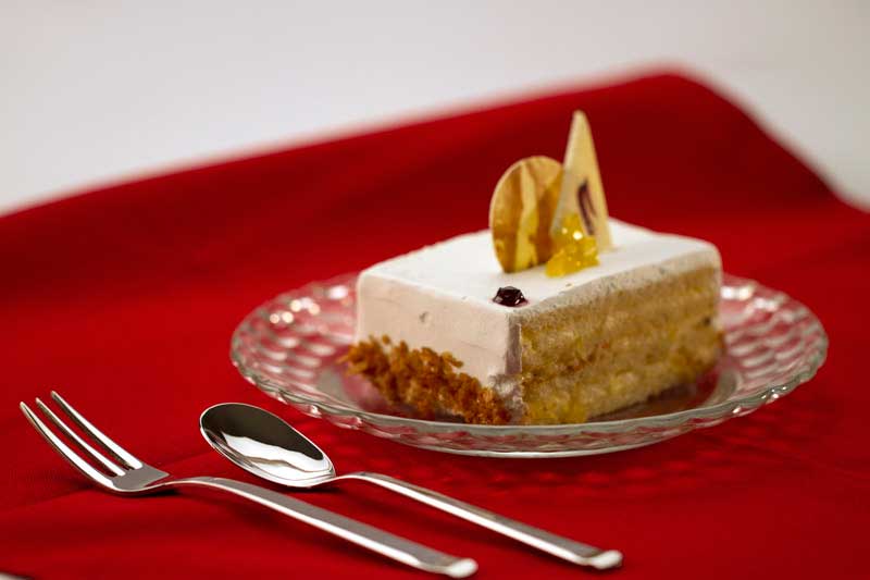 a piece of vanilla cake on a red cloth