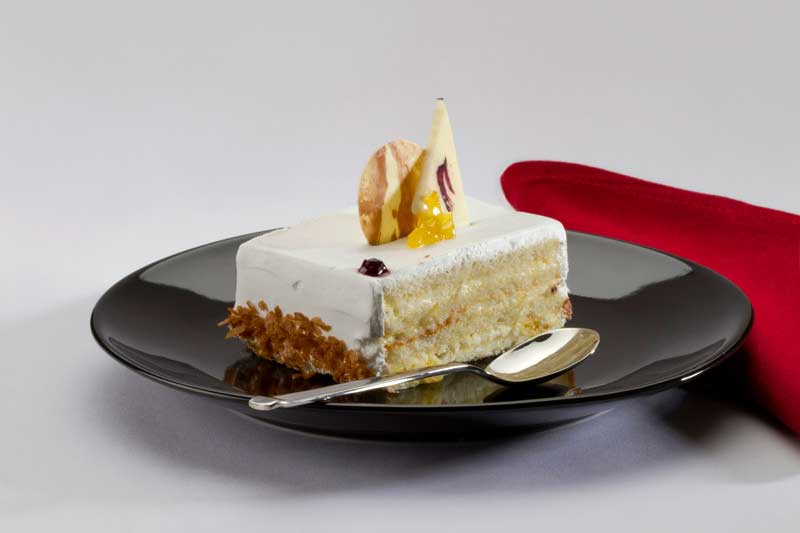 a slice of white chocolate cake served on table 