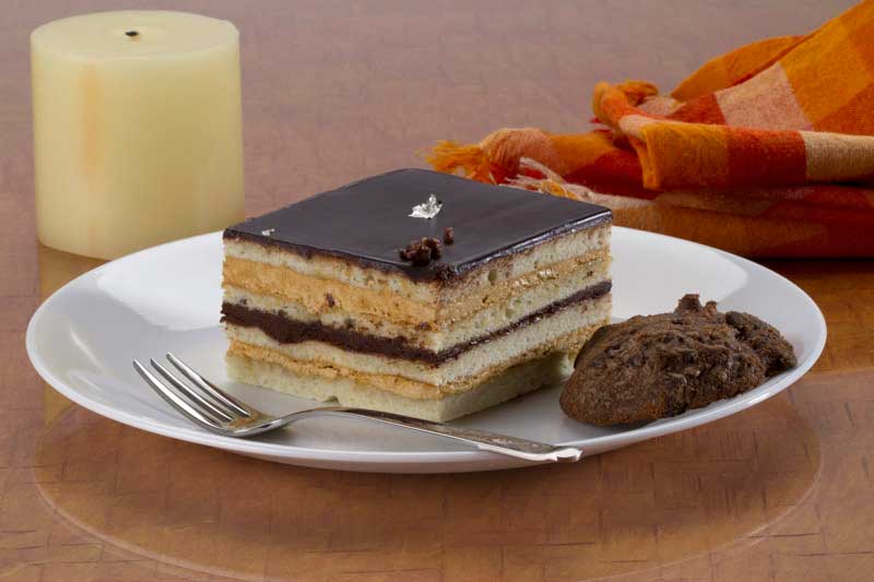 slice of cake served with cookies