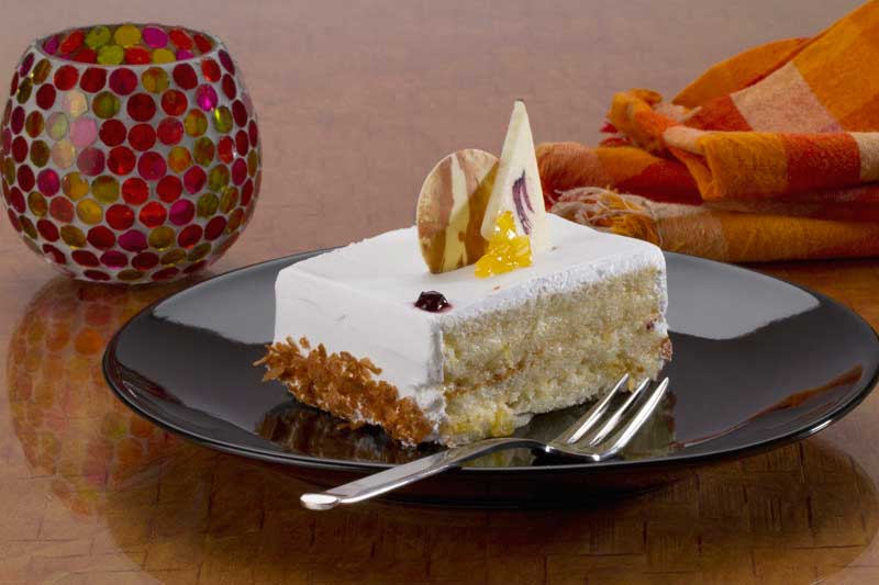 a slice of vanilla cake served on table 