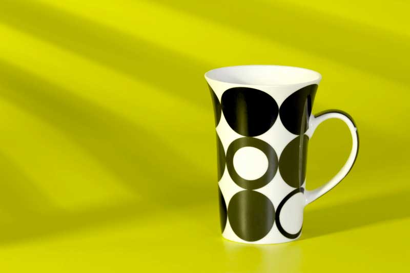 coffee cup against a yellow background