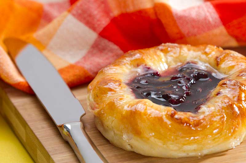 round bun with jelly and butter knife