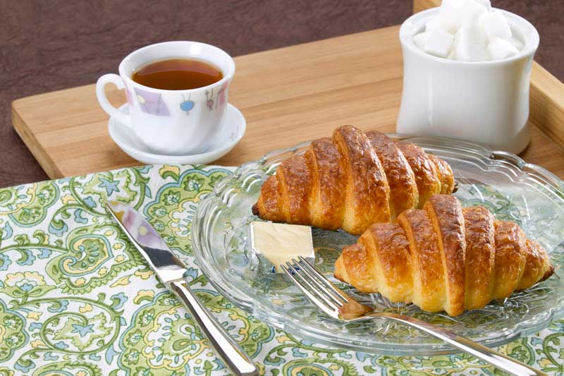 breakfast with sweet croissant and tea