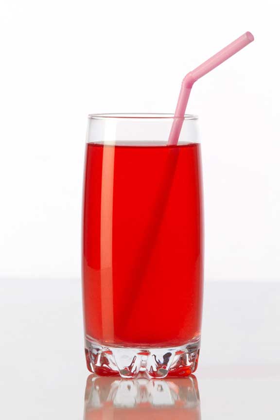 red coloured soft drink against a white background