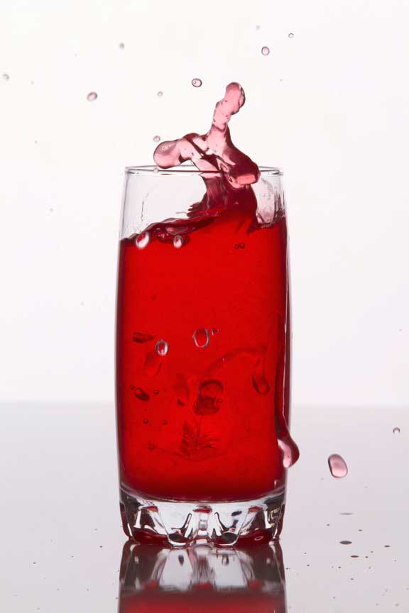 red coloured soft drink against a white background