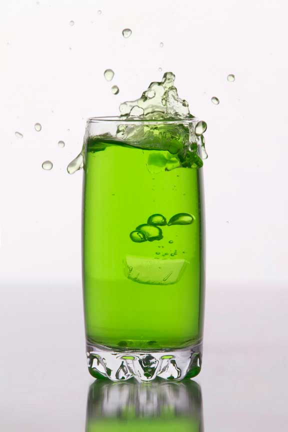 green coloured soft drink against a white background