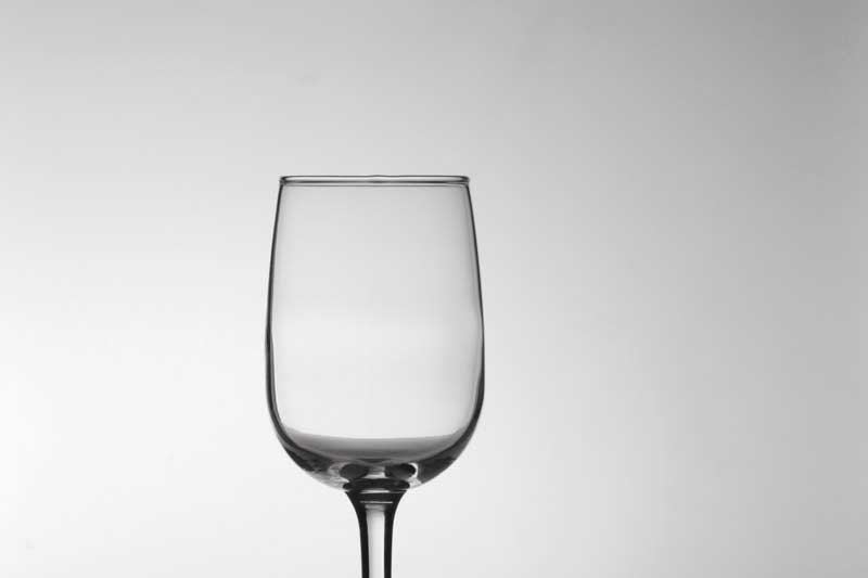 empty wine glass against white background