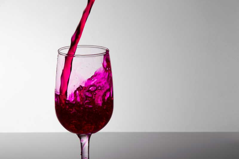 grape wine pouring into a wine glass
