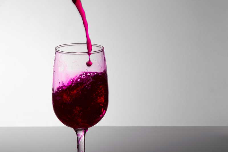 grape wine pouring into a wine glass