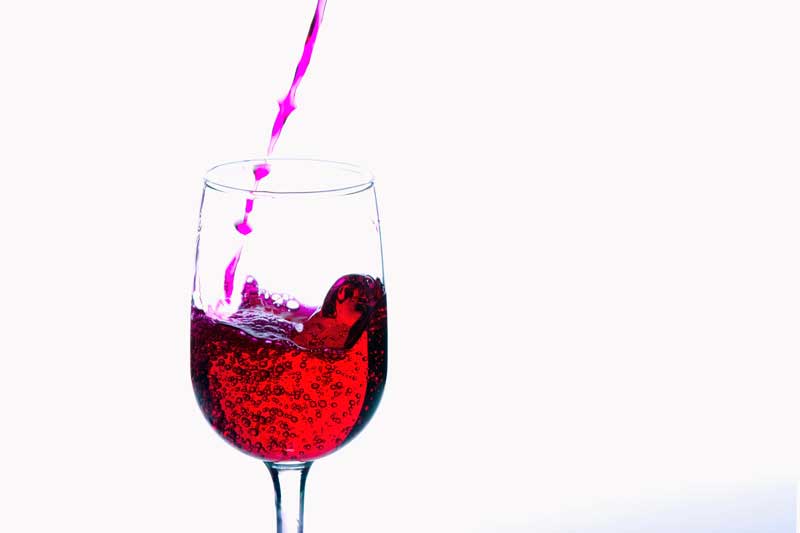 a glass of red wine in motion