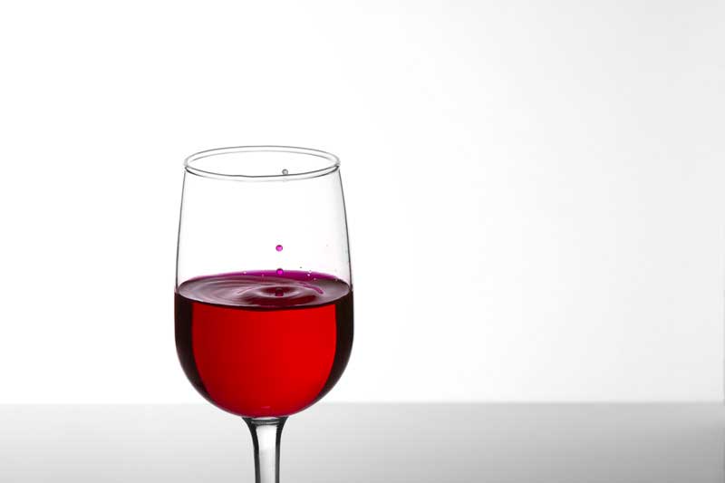 glass of wine against white background