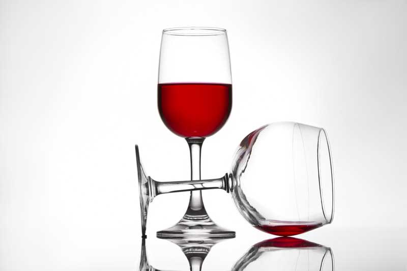 two wine glasses against a white background