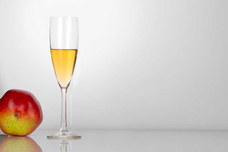 champagne glass with white background and apple