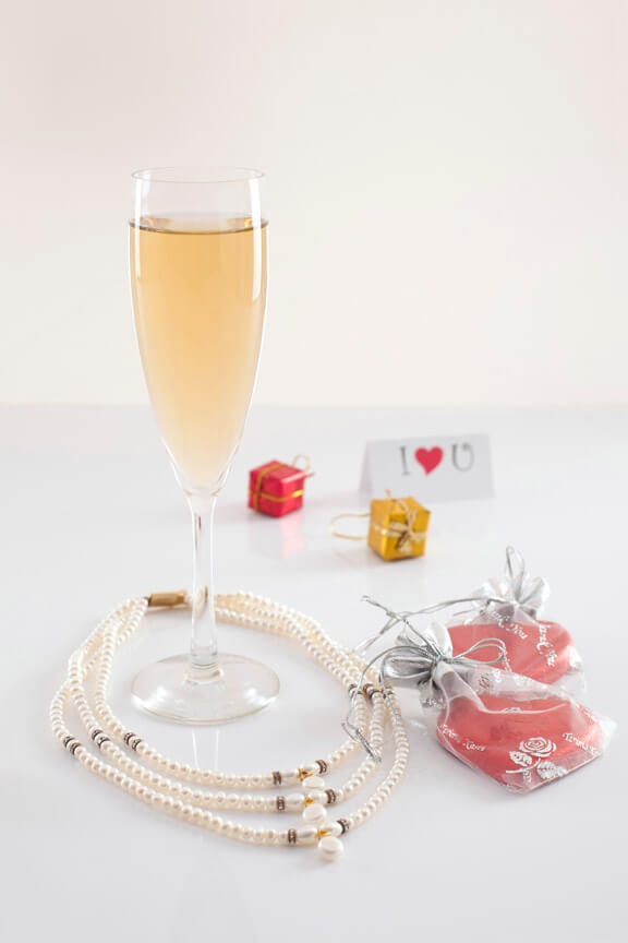 close up shot of a flute glass full of champagne on white background