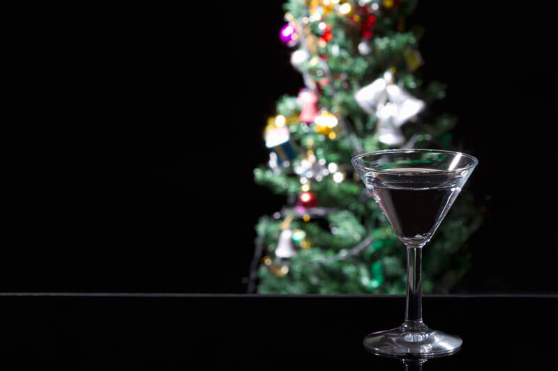 martini drink at the counter with christmas tree in the background