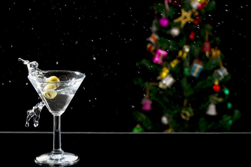a martini drink with olives in motion