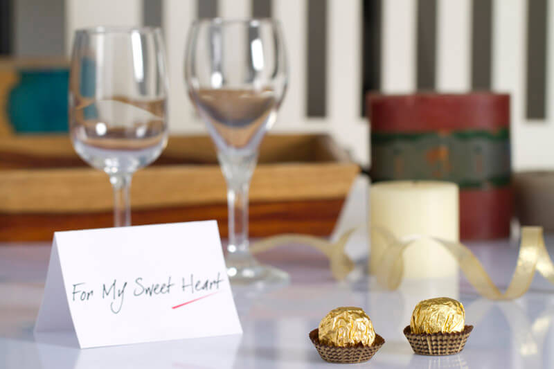 wine glasses and chocolates with love note