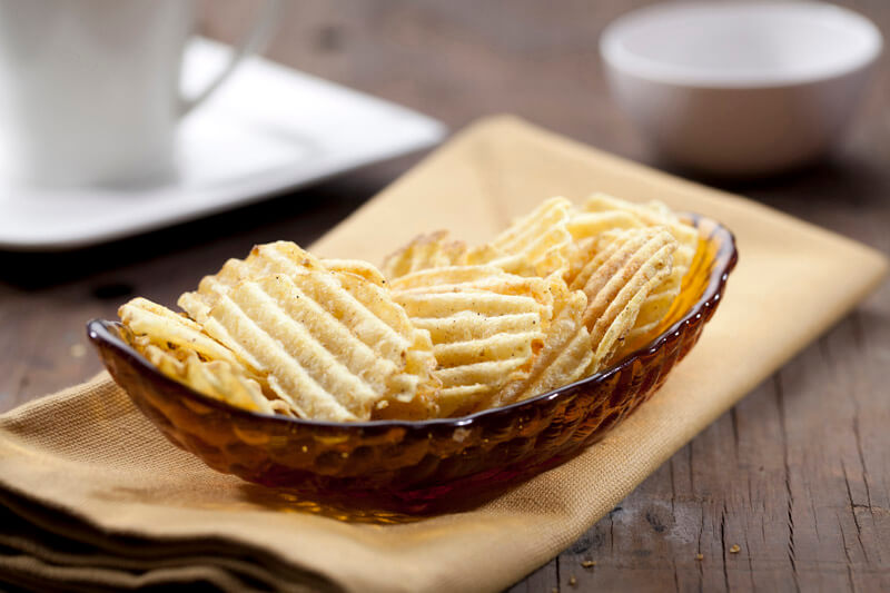grilled potato chips on a glass bowl