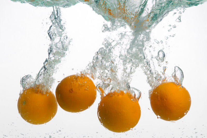 oranges in water against white background