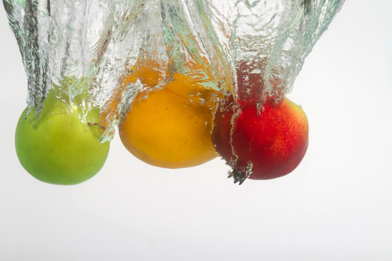 three multicoloured fruits in water
