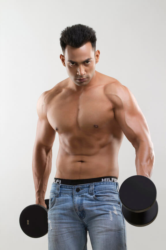 man posing with dumbbells