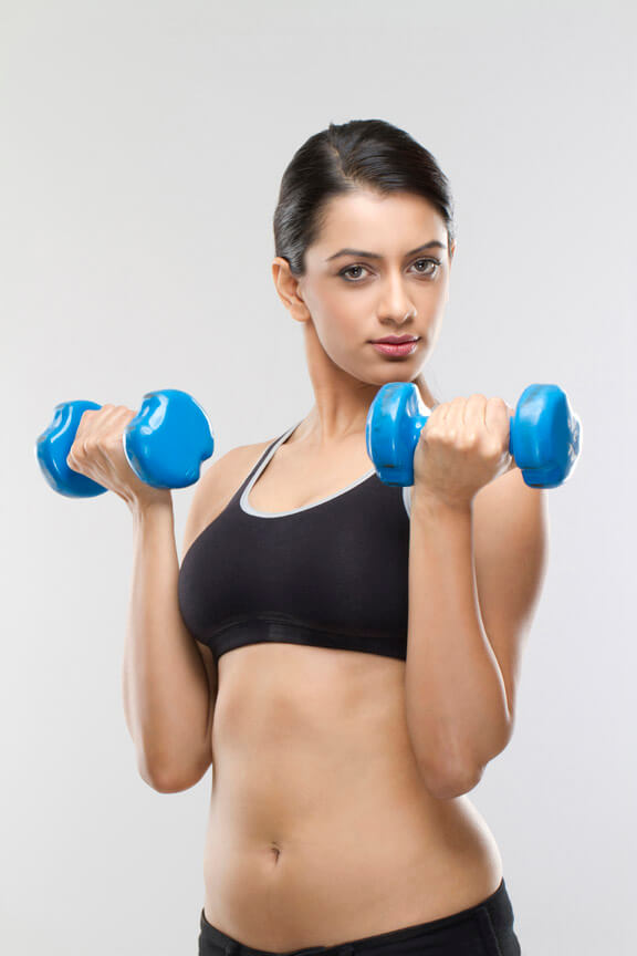 ,young female lifting blue coloured dumbbells