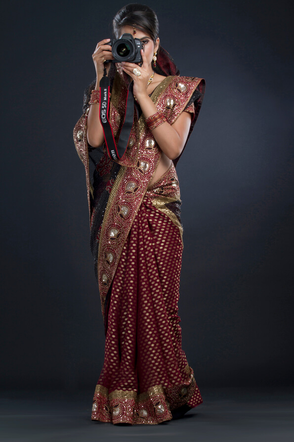 woman in an indian saree taking a picture