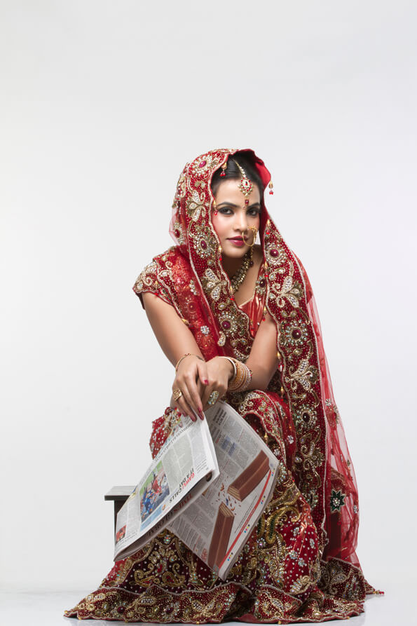 indian bride with a newspaper 