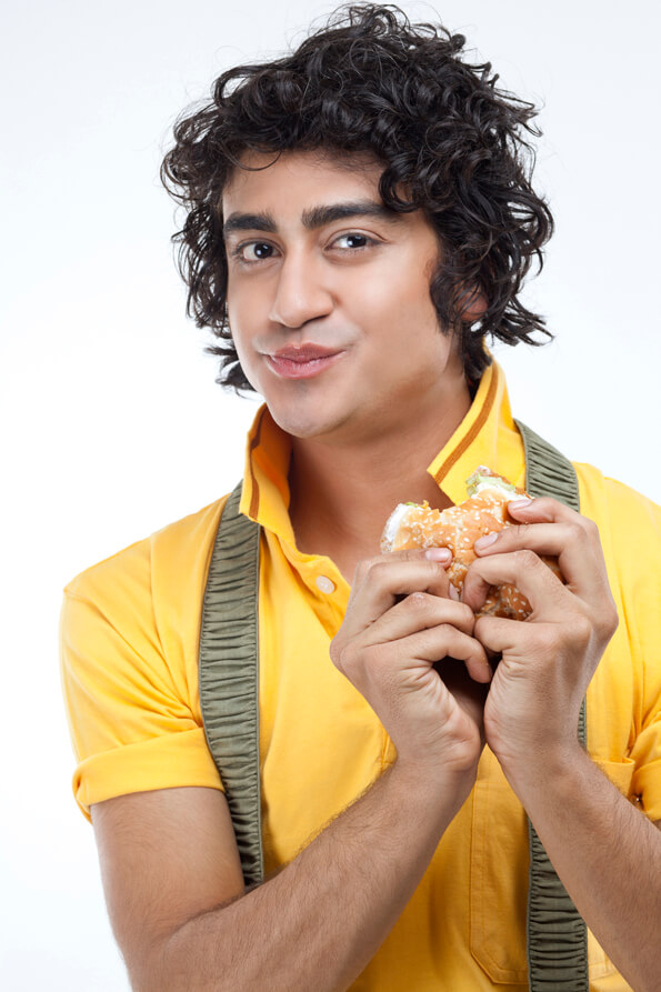 close-up of a boy eating a burger