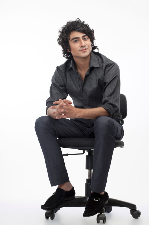 a young confident guy sitting on chair