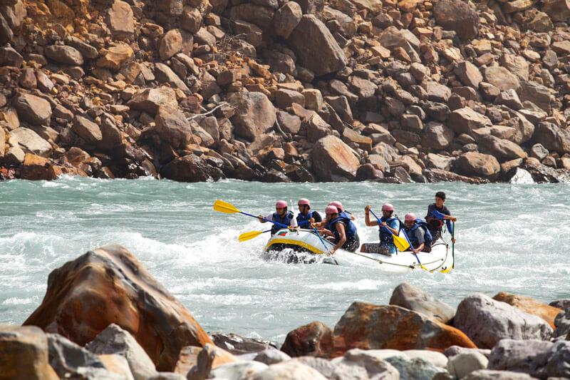 men rafting with guide at rishikesh