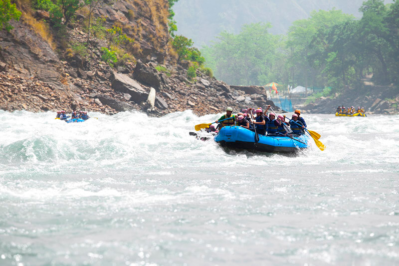 men in action while river rafting at rishikesh