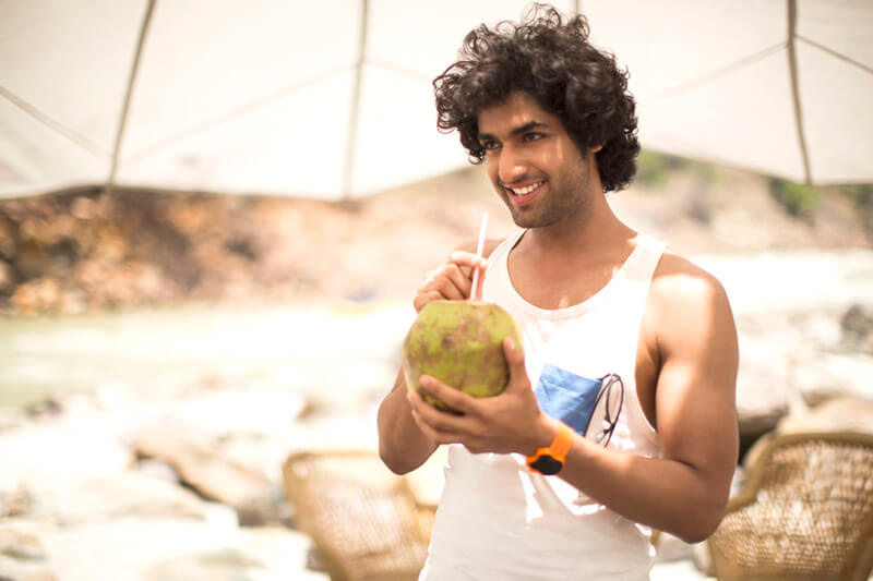 guy sipping coconut water