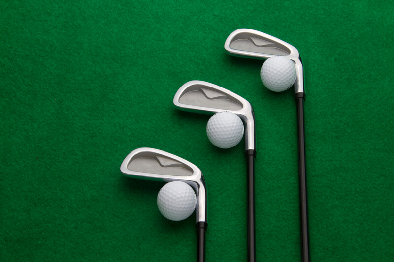 a set of golf stick with balls 