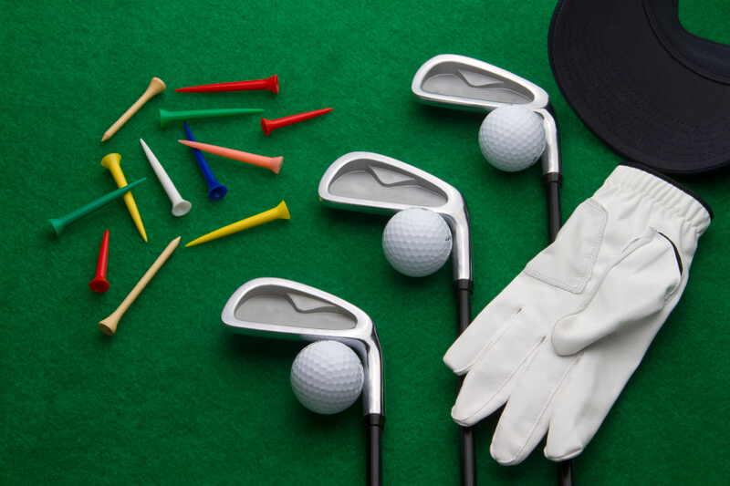 golf clubs balls flagstick tee and gloves